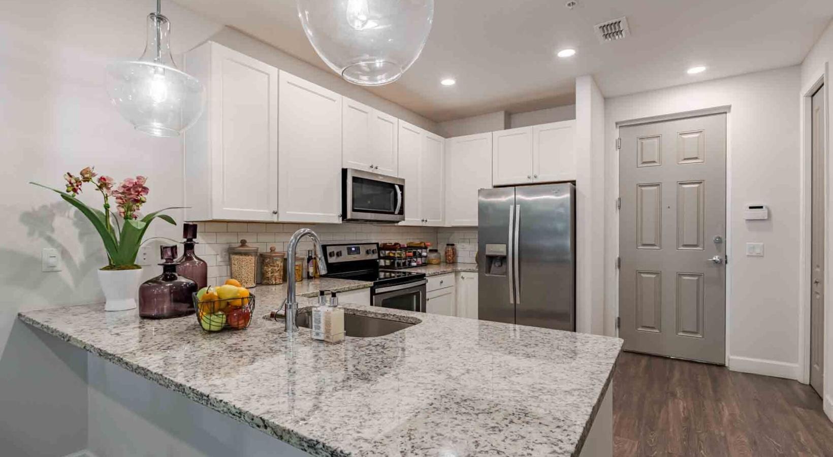 a kitchen with white cabinets