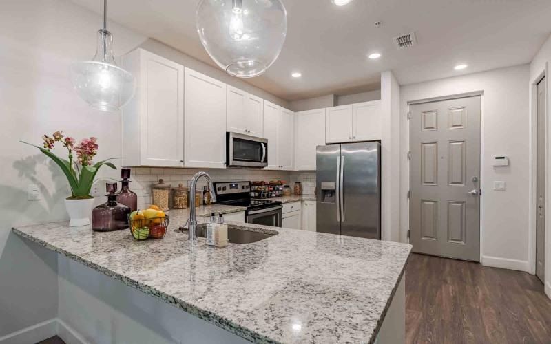 a kitchen with white cabinets
