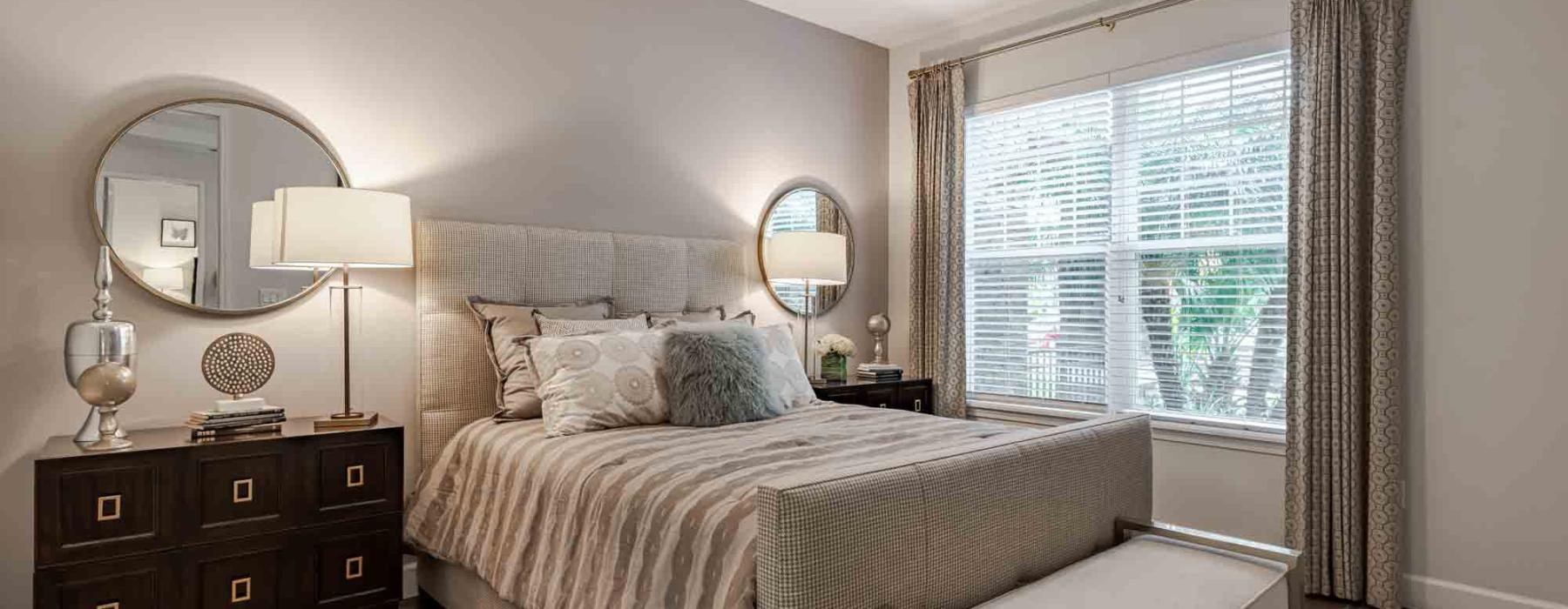 a bedroom with a bed and a mirror