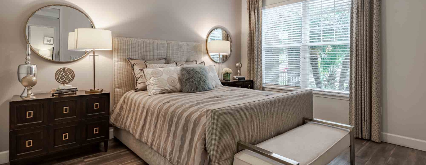 a bedroom with a bed and a mirror